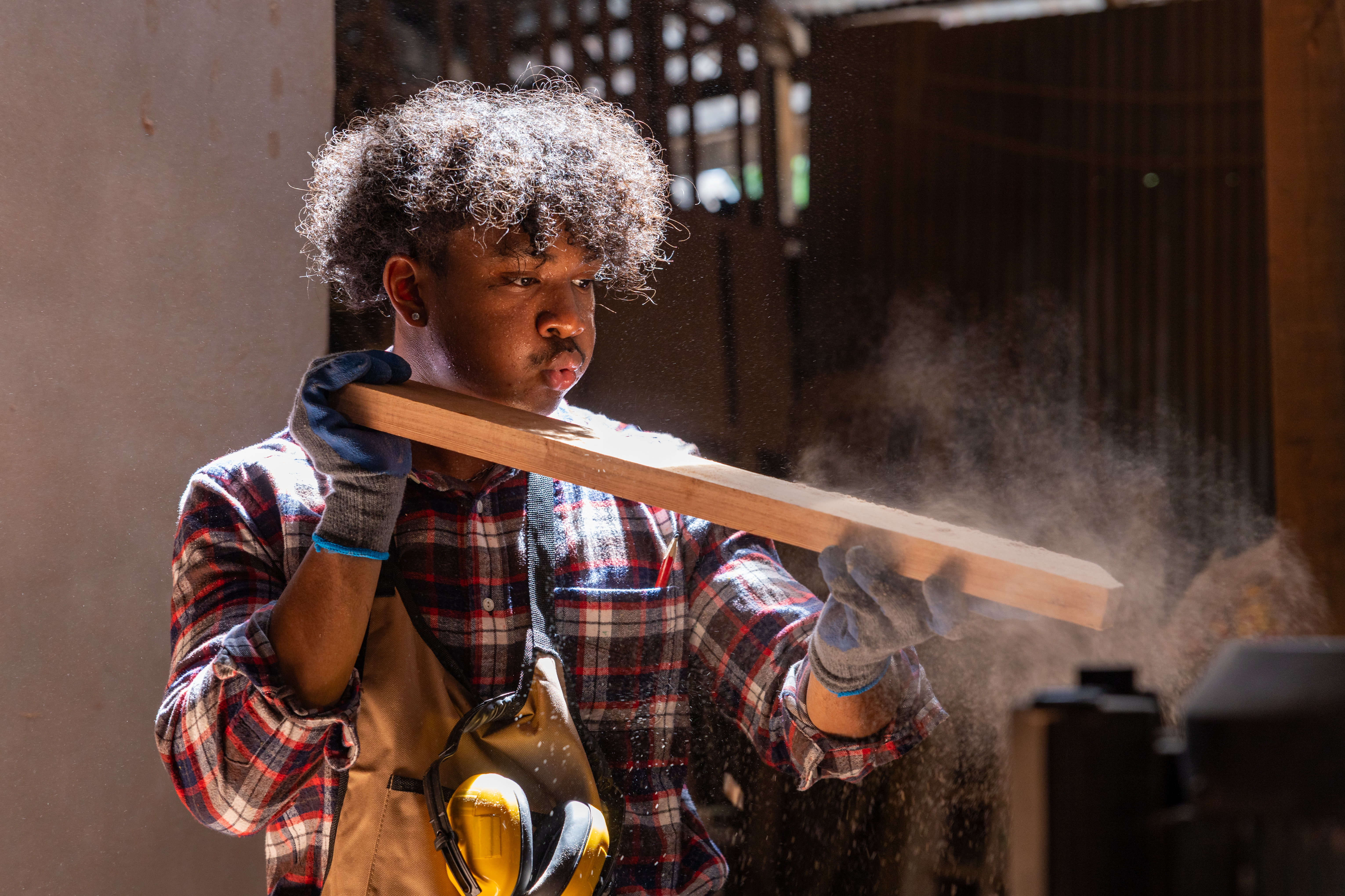 Woodworker working on DIY project with sawdust