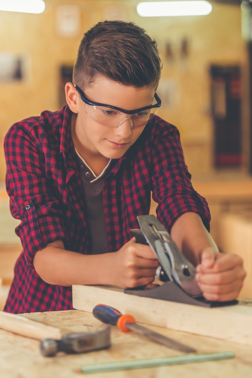 Parent and child working together on woodworking DIY project