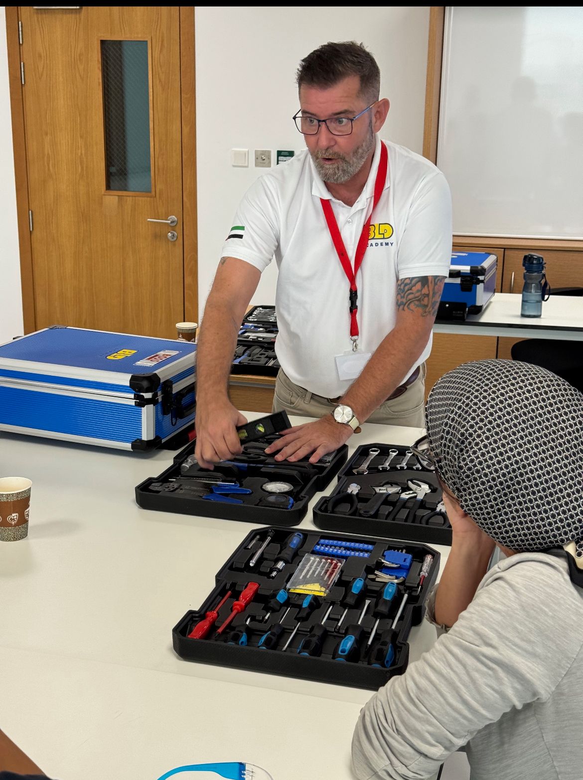 BLD Academy instructor demonstrating tools to a student